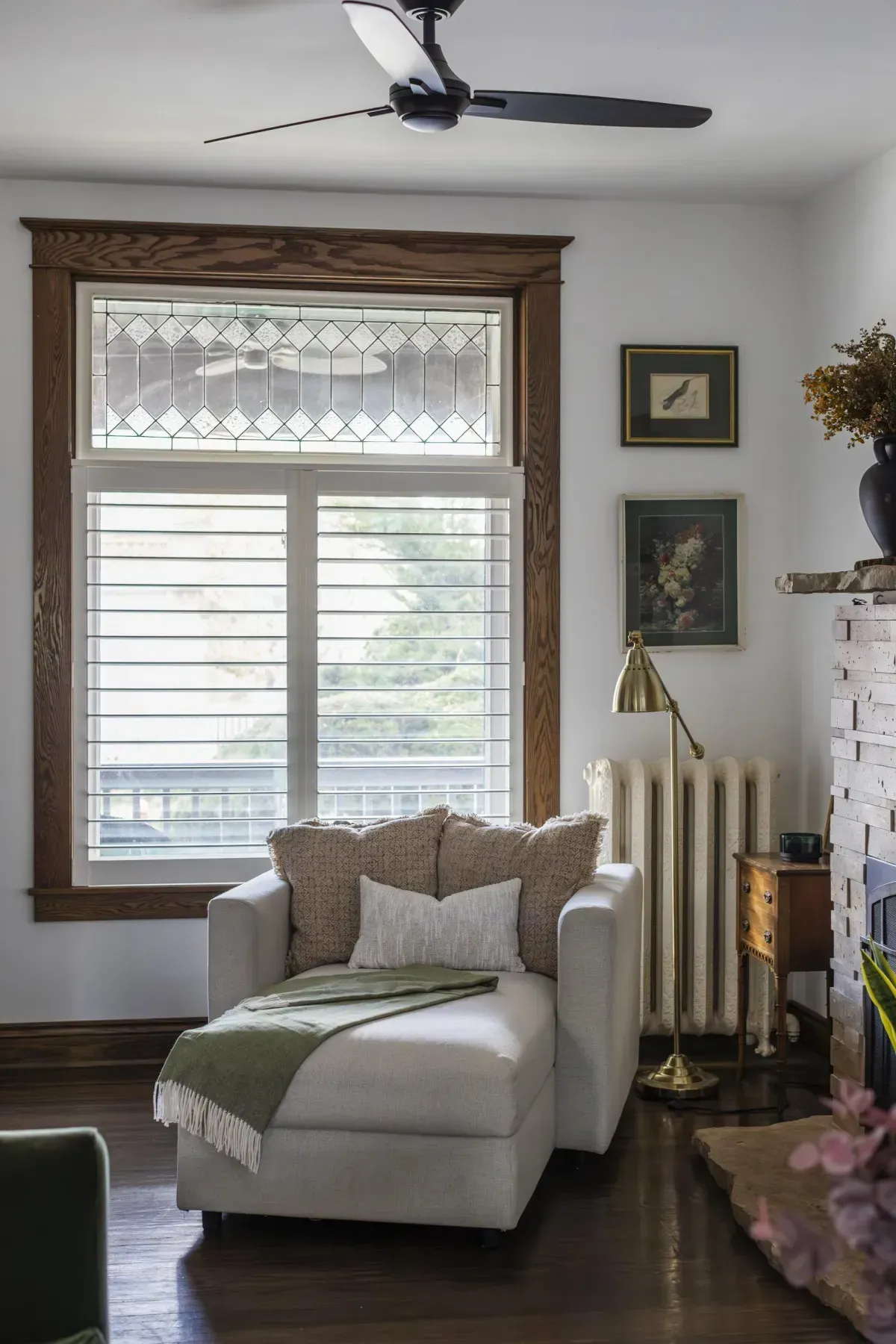 Front living room at 109 Fairleigh Ave S Hamilton featuring restored original hardwood floors, gas fireplace, with natural light.