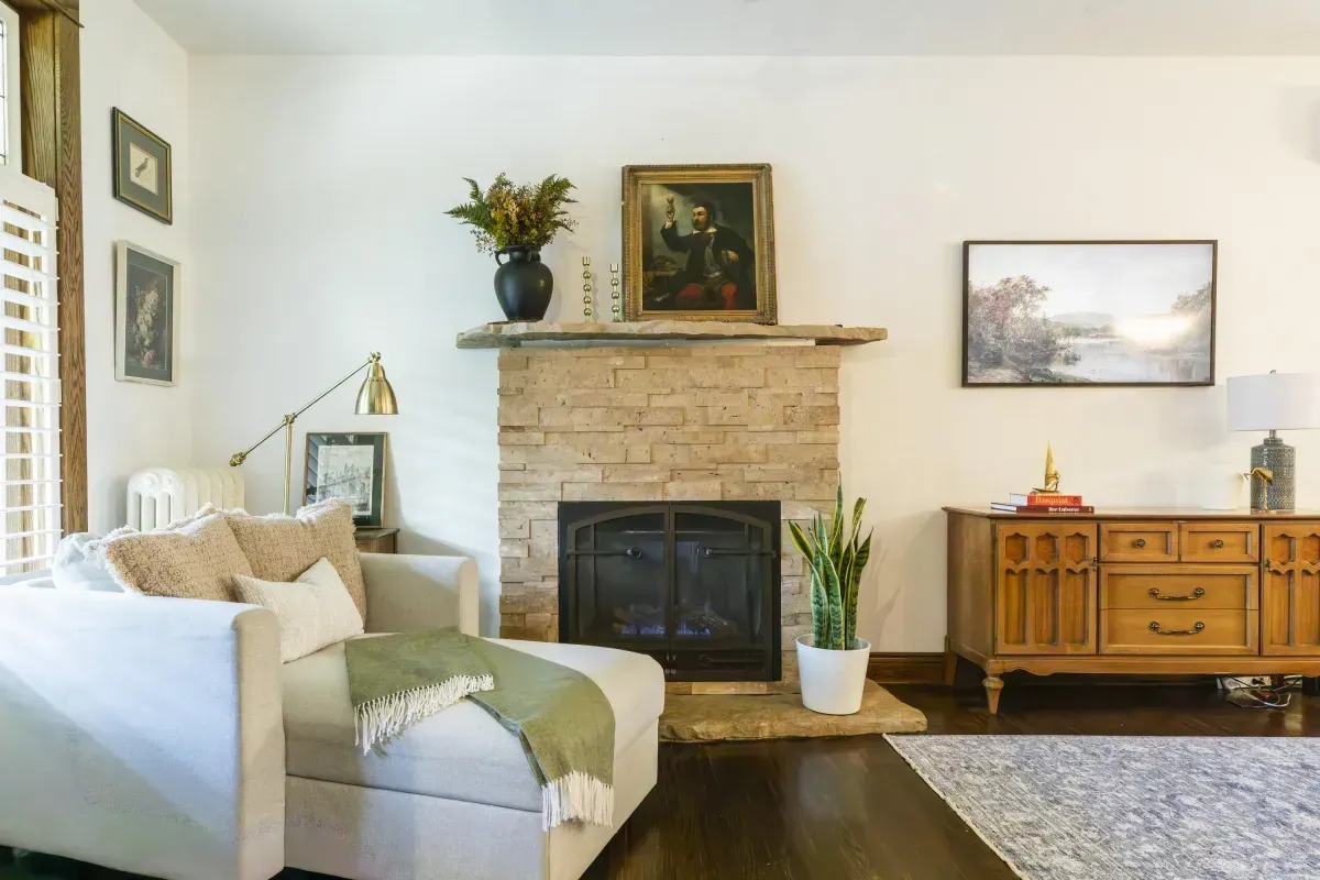 Front living room at 109 Fairleigh Ave S Hamilton featuring restored original hardwood floors, gas fireplace, with natural light.