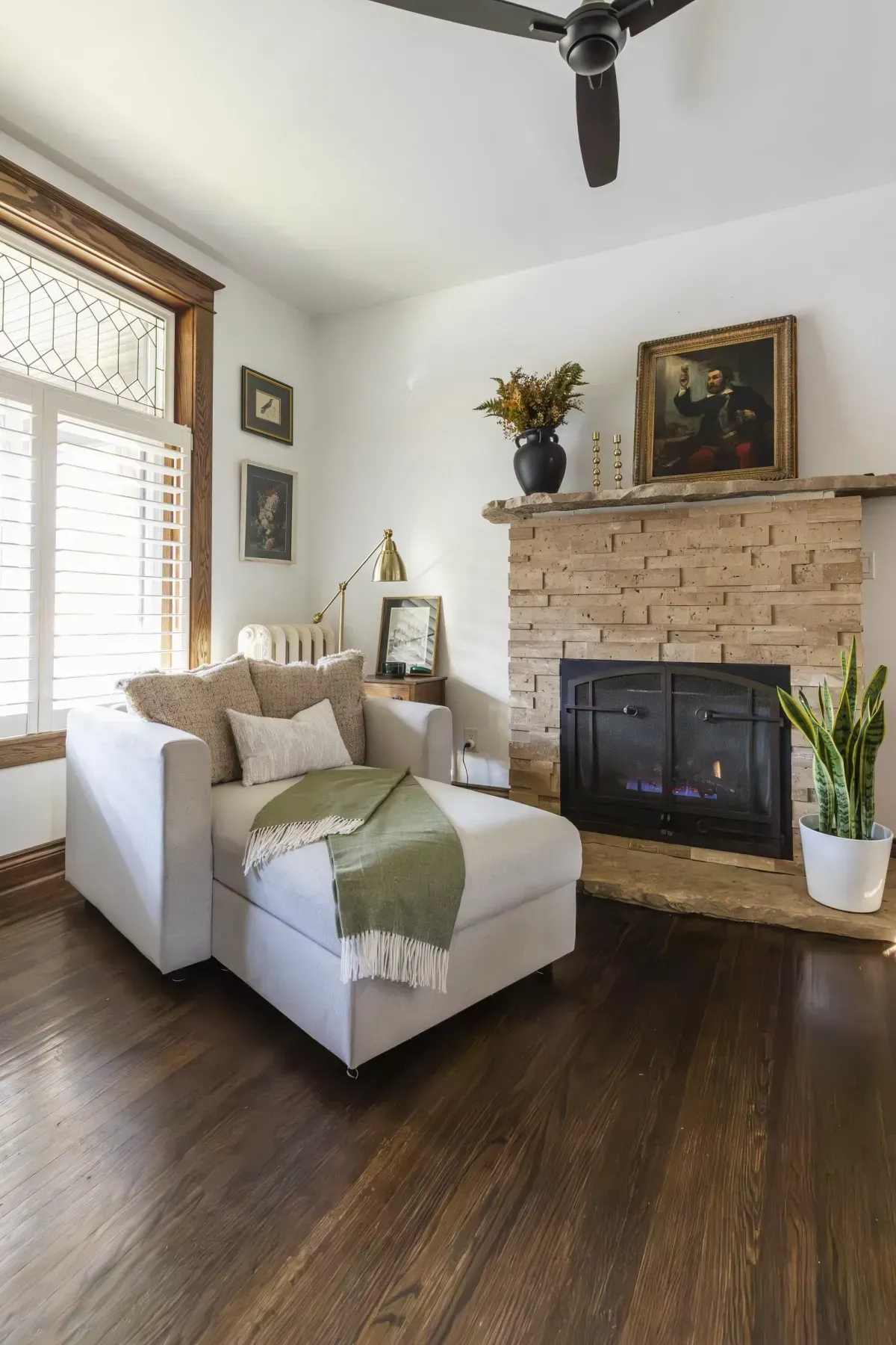 Front living room at 109 Fairleigh Ave S Hamilton featuring restored original hardwood floors, gas fireplace, with natural light.