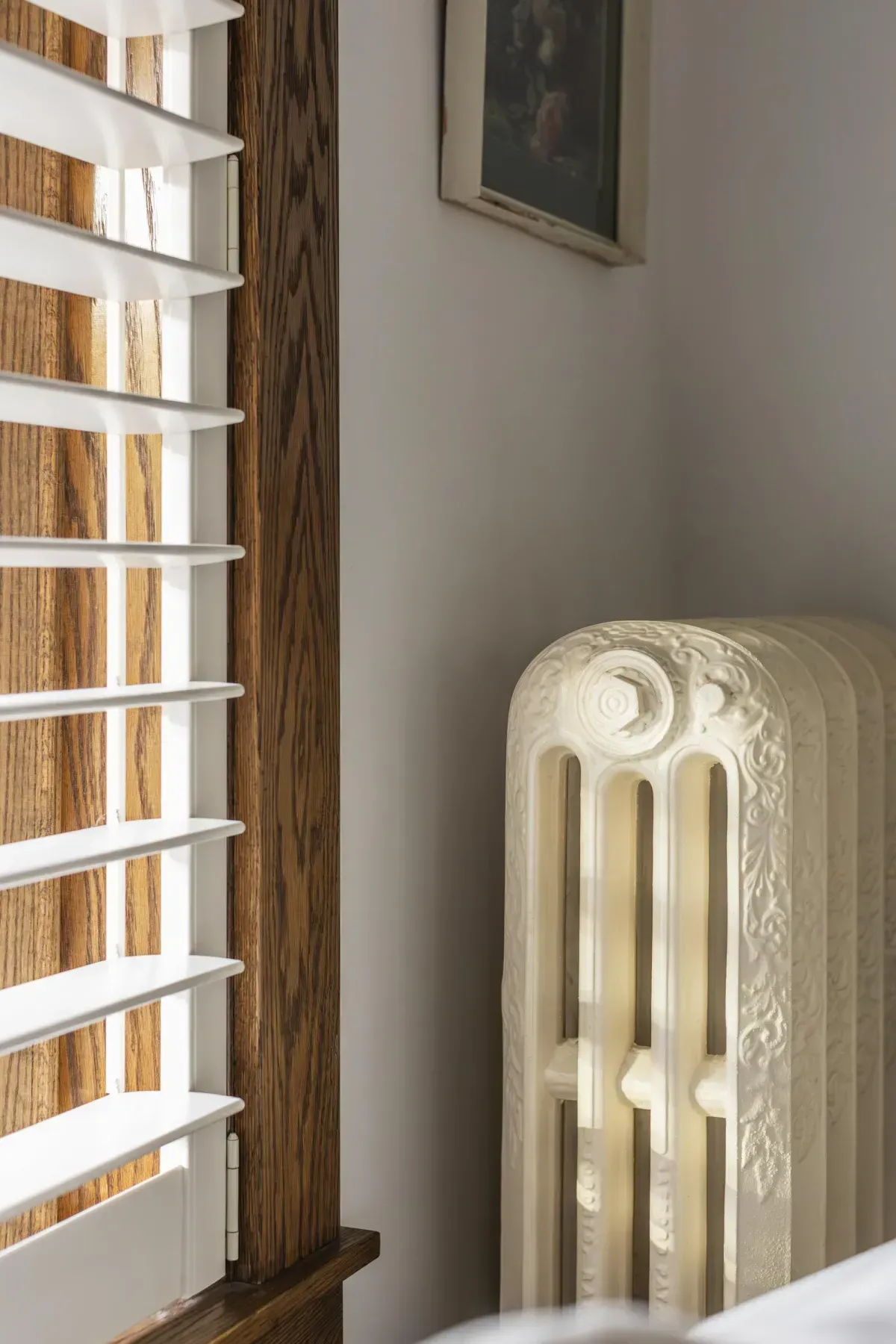 Front living room at 109 Fairleigh Ave S Hamilton featuring restored original hardwood floors, gas fireplace, with natural light.