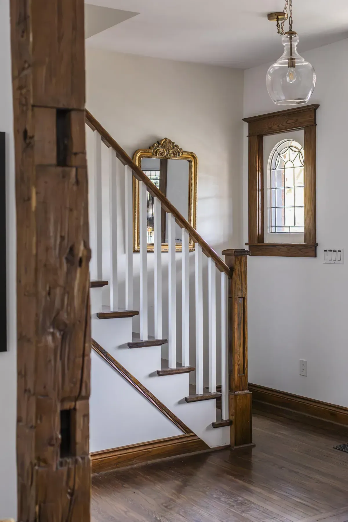 Front living room at 109 Fairleigh Ave S Hamilton featuring restored original hardwood floors, gas fireplace, with natural light.