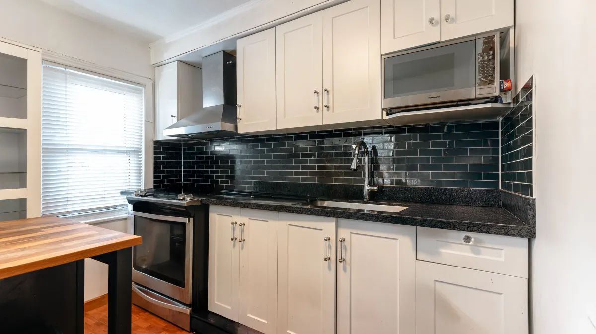 Functional kitchen at 81 Lambton Ave equipped with stainless steel appliances and a practical move-in-ready layout.