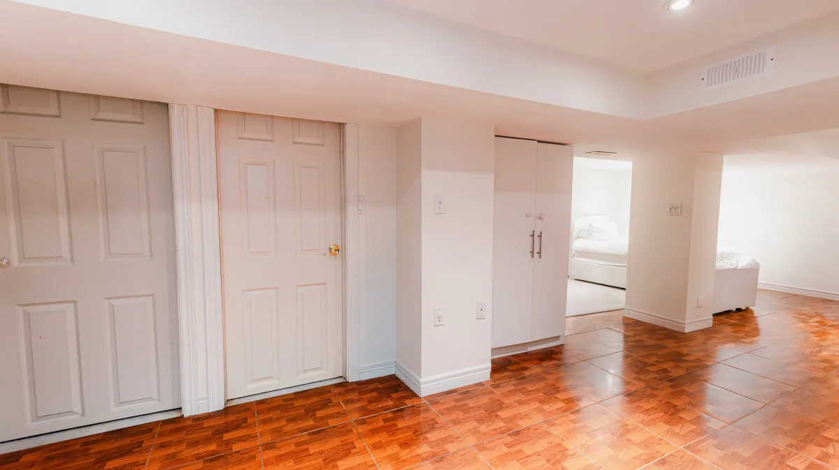 Versatile finished basement at 81 Lambton Ave with durable tile flooring, ideal for a 3rd bedroom or media room.