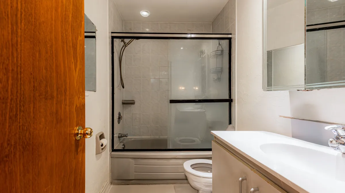 Clean and bright 4-piece bathroom located on the main level of 81 Lambton Ave, Toronto.