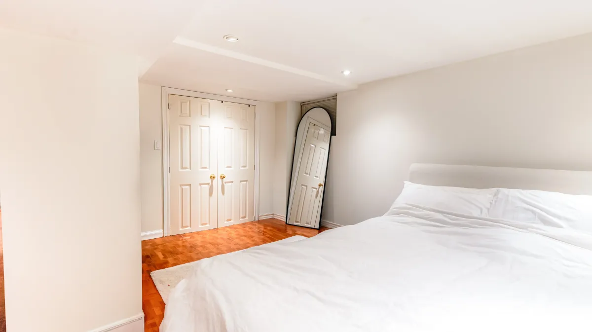 Versatile finished basement at 81 Lambton Ave with durable tile flooring, ideal for a 3rd bedroom or media room.