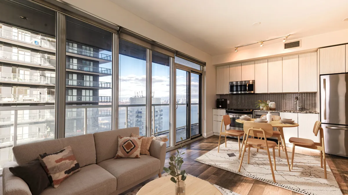 Sun-filled open-concept living space at 56 Annie Craig Dr #3408 featuring soaring floor-to-ceiling windows.