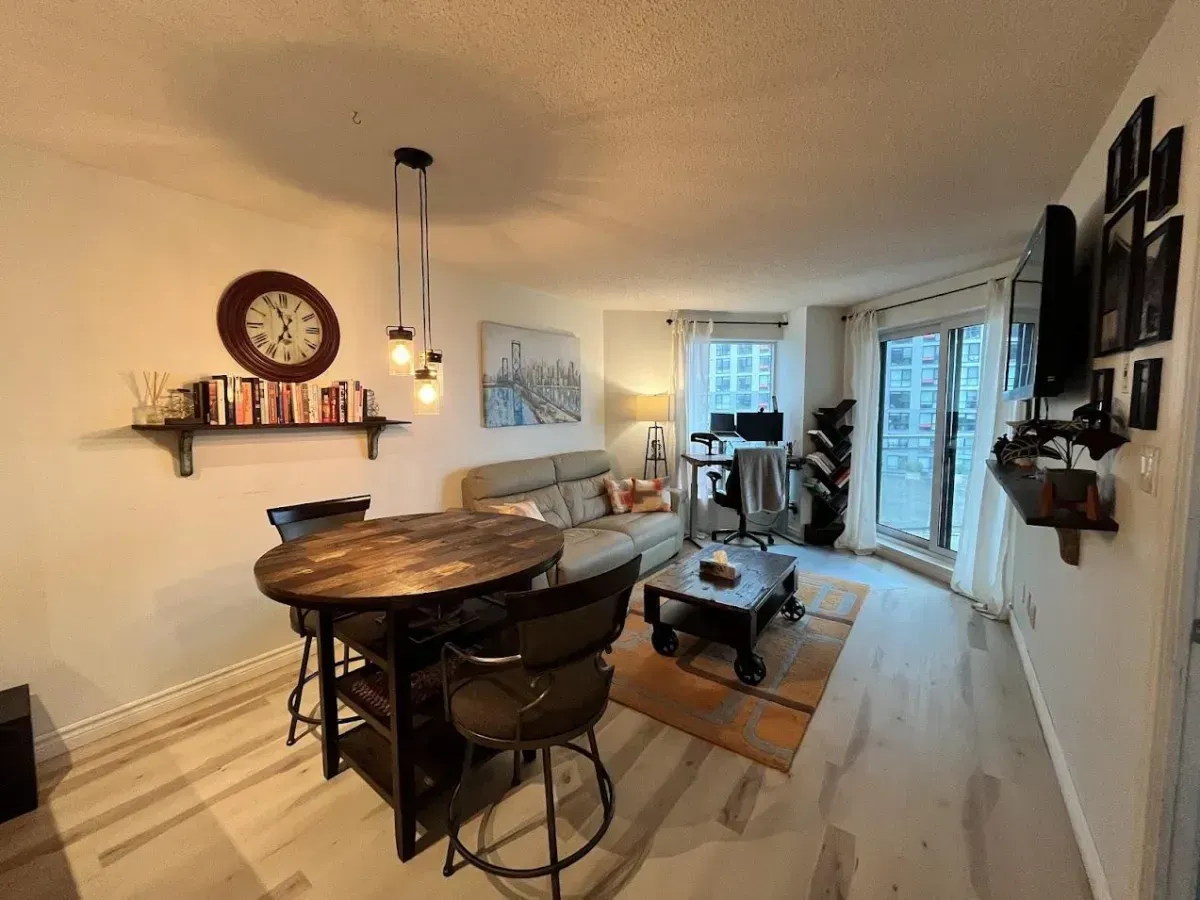 Sun-filled 1-bedroom suite at 410 Queens Quay W featuring designer finishes and a walk-out to the balcony.