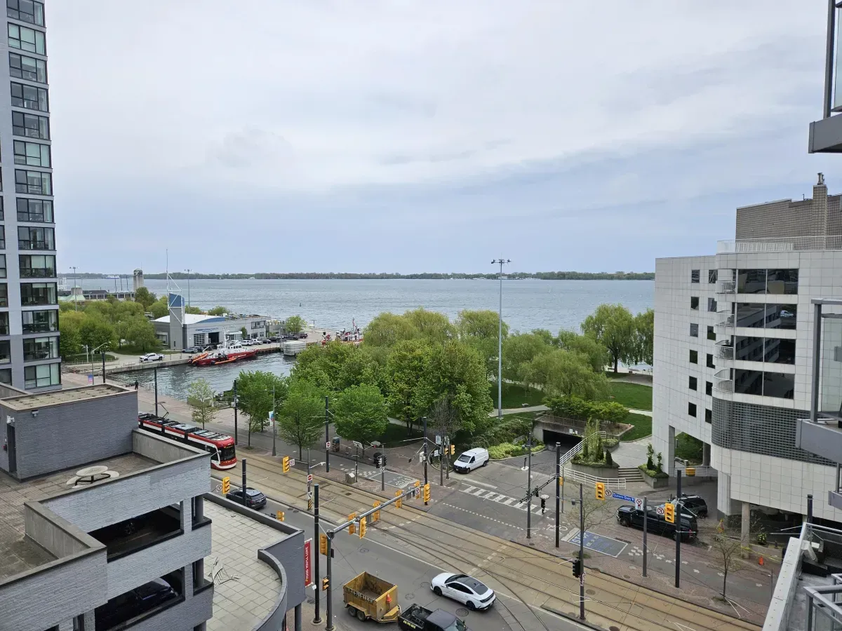 Serene waterfront view of Lake Ontario and the Martin Goodman Trail from a private balcony at Aqua.