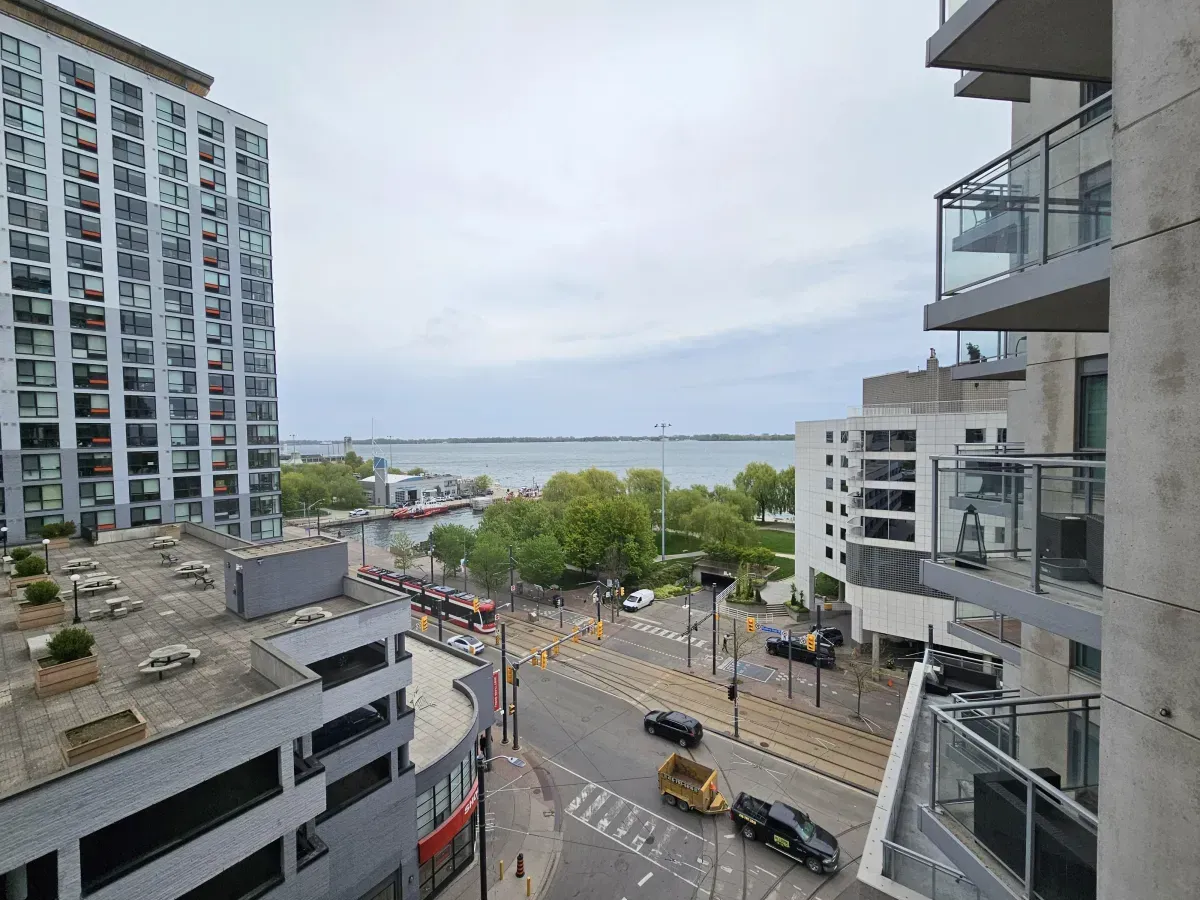 Serene waterfront view of Lake Ontario and the Martin Goodman Trail from a private balcony at Aqua.
