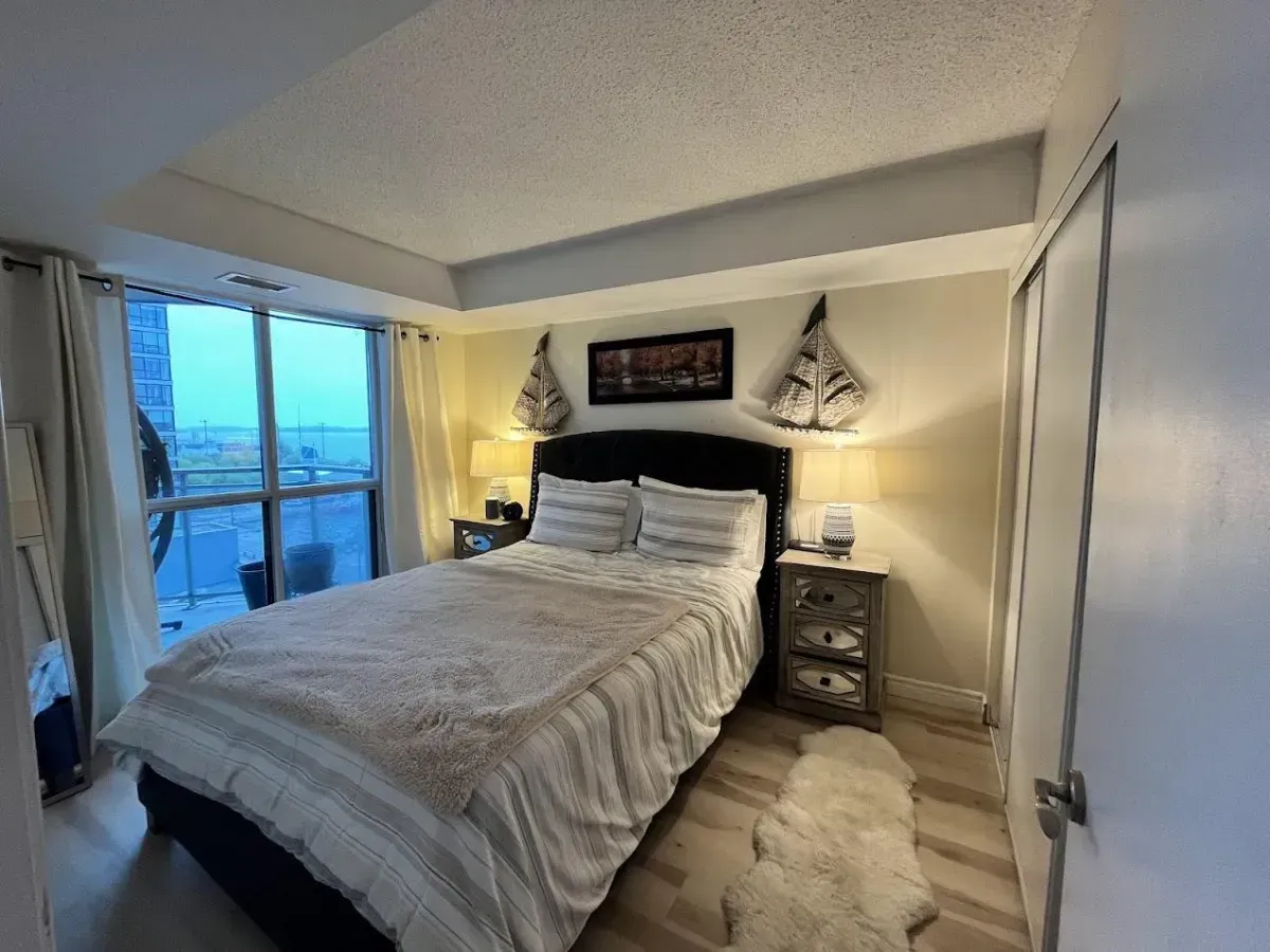 Spacious 1-bedroom sanctuary at 410 Queens Quay W with floor-to-ceiling windows and sunrise lake views.