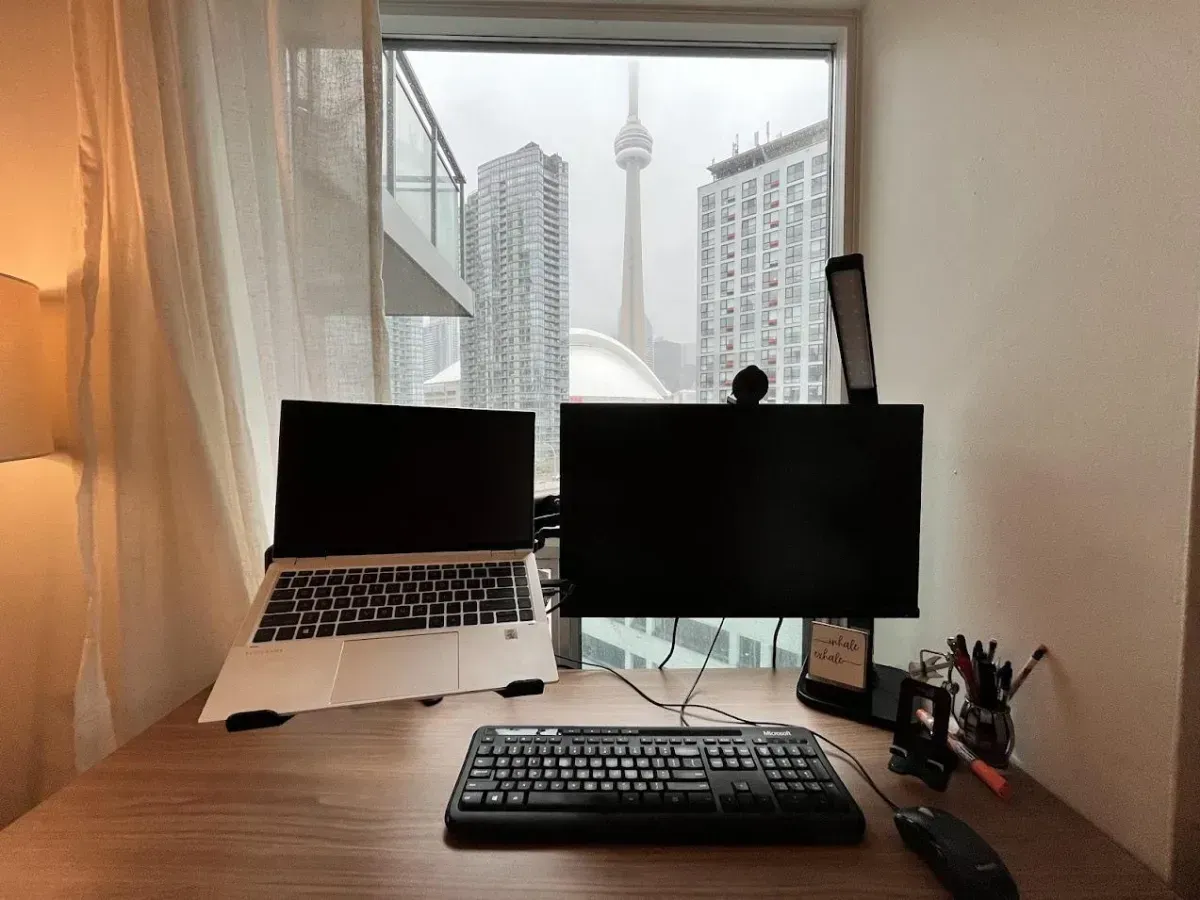 Dedicated workspace in suite 812 at 410 Queens Quay W with a direct view of the CN Tower and Rogers Centre.