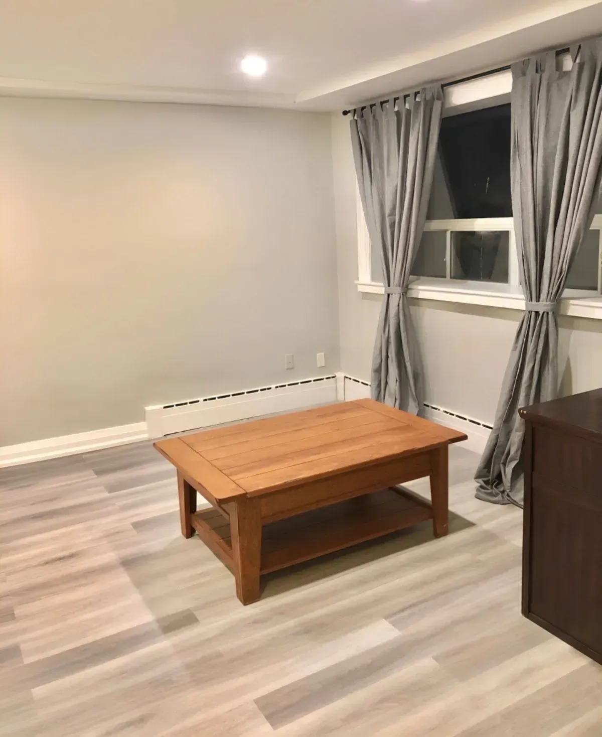 Bright and spacious main-floor living area with contemporary wide-plank flooring and recessed pot lighting in York, Ontario.