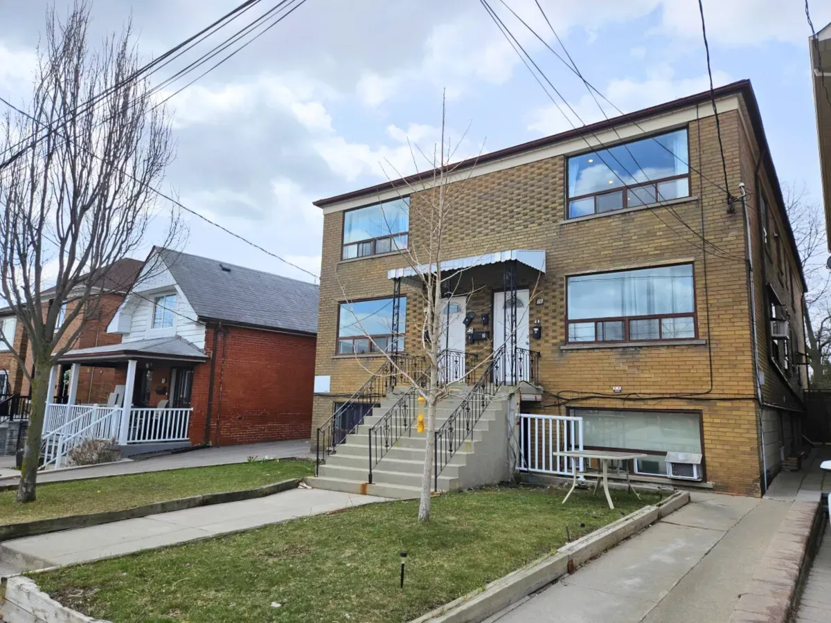 Two-story brick residential building at 36 Branstone Rd in the Caledonia-Fairbank neighborhood of Toronto.