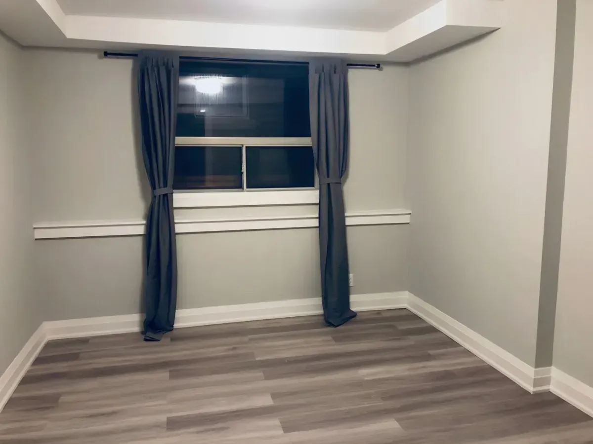 Bright and spacious main-floor living area with contemporary wide-plank flooring and recessed pot lighting in York, Ontario.
