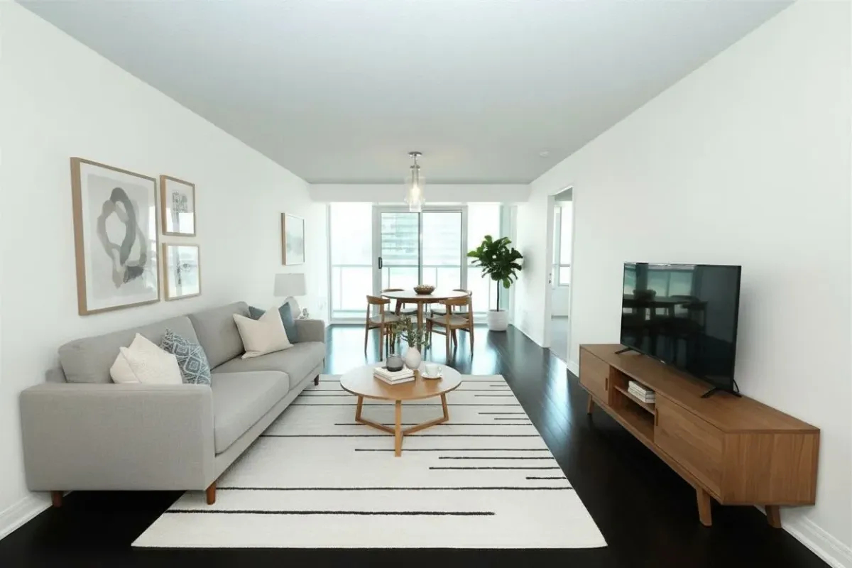 Modern open-concept living room with laminate floors at 30 Grand Trunk Crescent Unit 509 Toronto South Core.