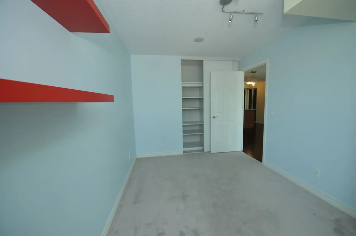 Primary bedroom with large windows and split-bedroom layout at 30 Grand Trunk Crescent Unit 509 Toronto.