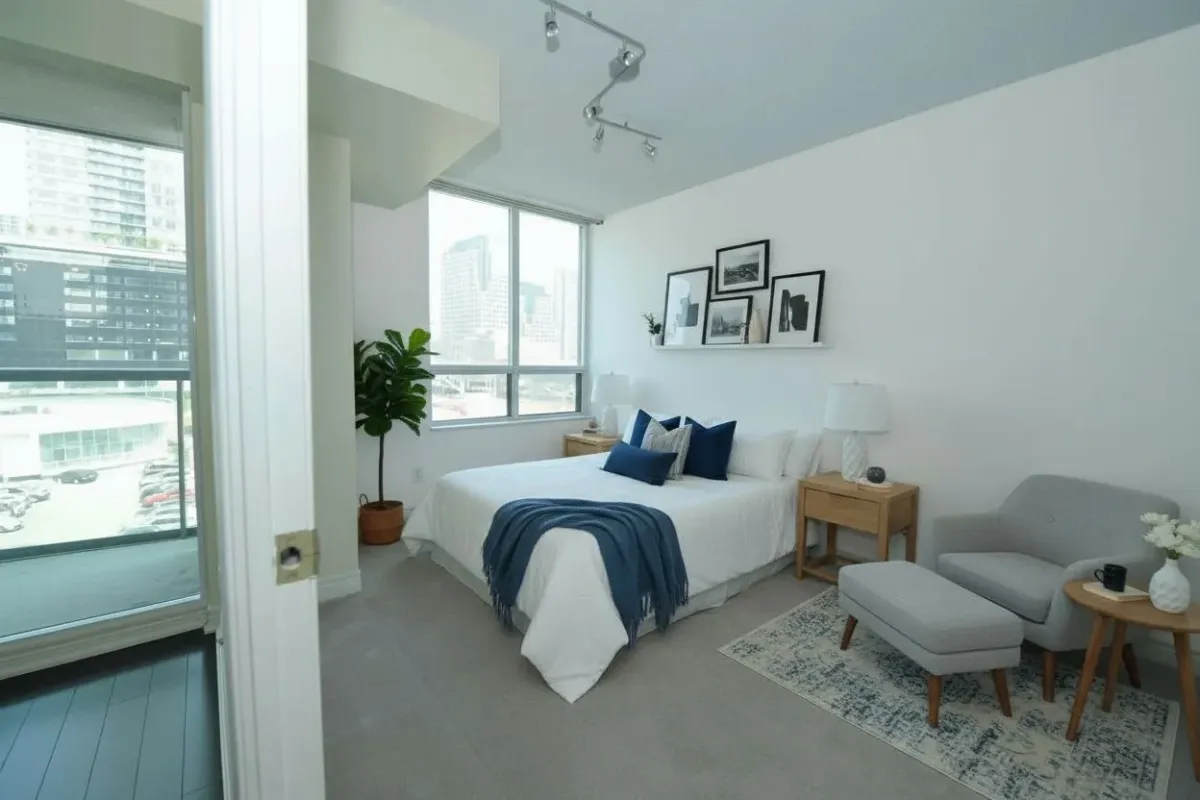 Primary bedroom with large windows and split-bedroom layout at 30 Grand Trunk Crescent Unit 509 Toronto.