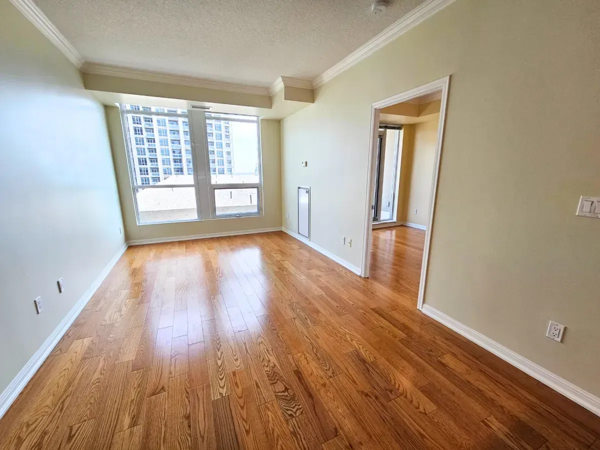 Bright living area at 628 Fleet St featuring 9-foot ceilings, rich hardwood flooring, and large windows.