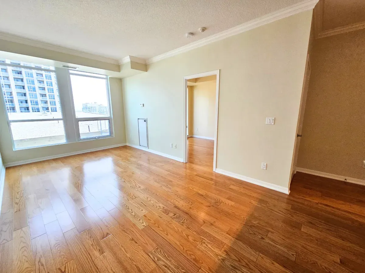 Bright living area at 628 Fleet St featuring 9-foot ceilings, rich hardwood flooring, and large windows.