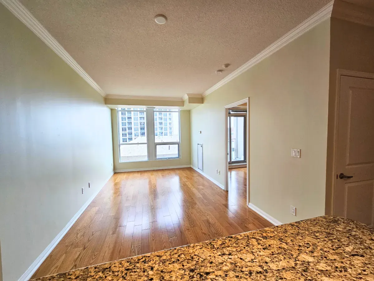 Bright living area at 628 Fleet St featuring 9-foot ceilings, rich hardwood flooring, and large windows.