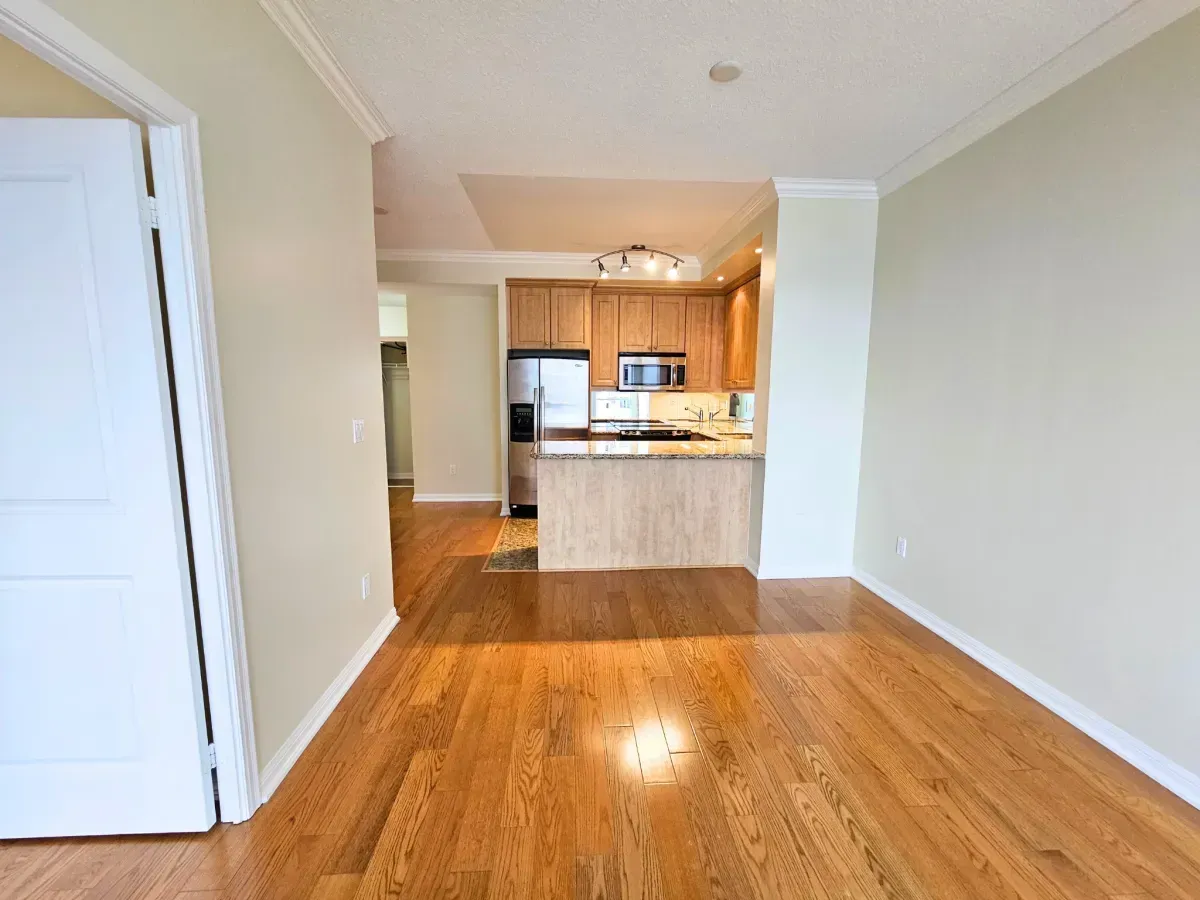 Modern kitchen at 628 Fleet St #1311 featuring granite countertops, a breakfast bar, and stainless steel appliances.