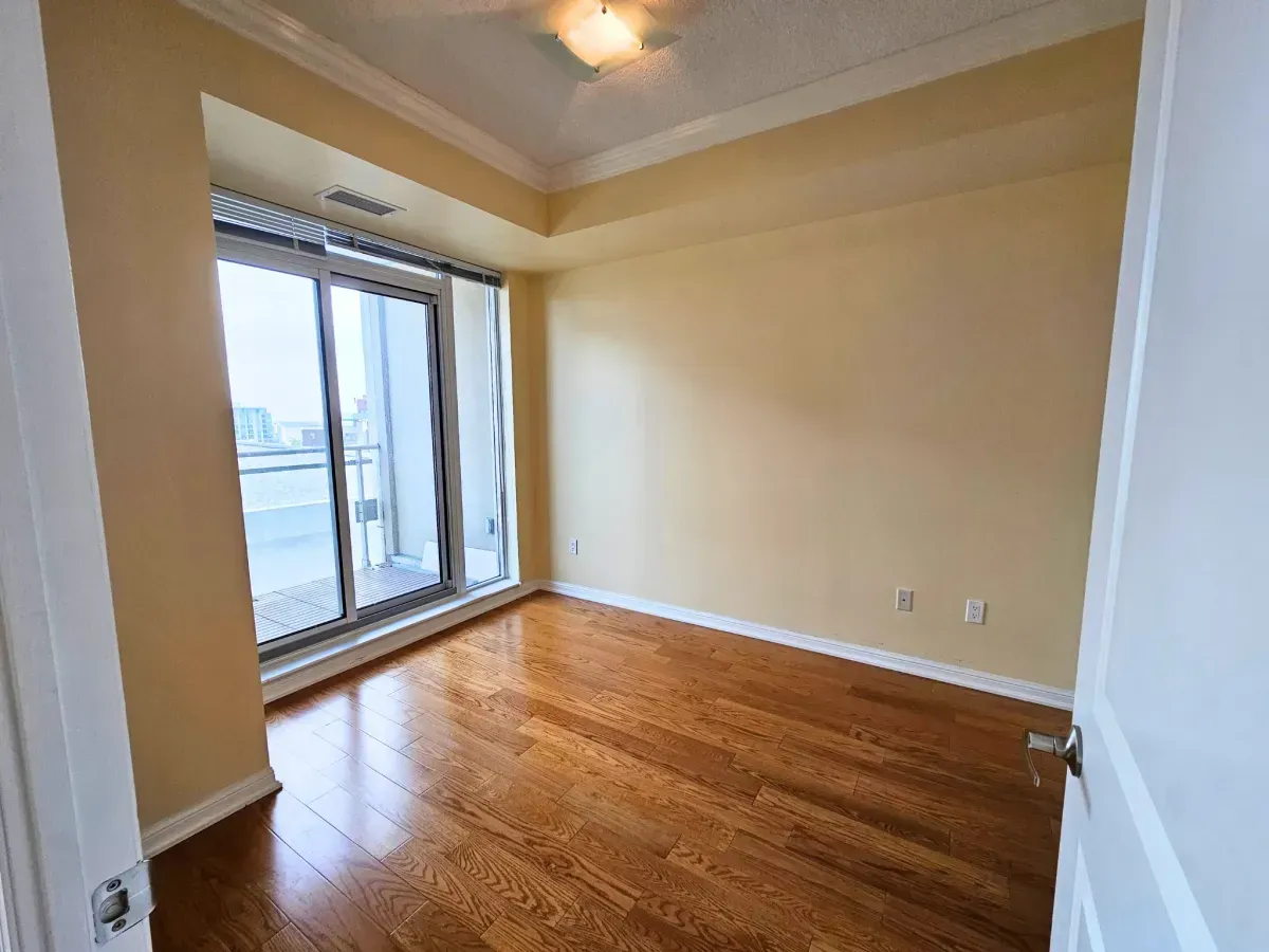Tranquil 1-bedroom sanctuary at 628 Fleet St with hardwood floors and sliding glass door access to the balcony.