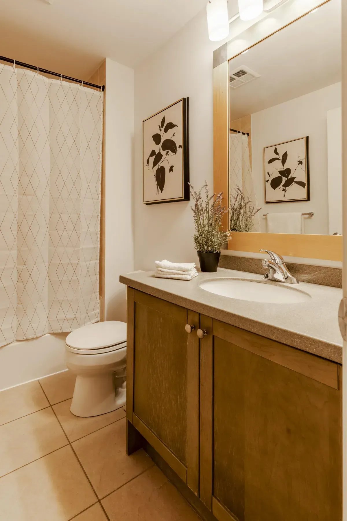 Modern wood-finish vanity and large mirror in the bathroom at 5 Marine Parade Dr #630, Etobicoke.