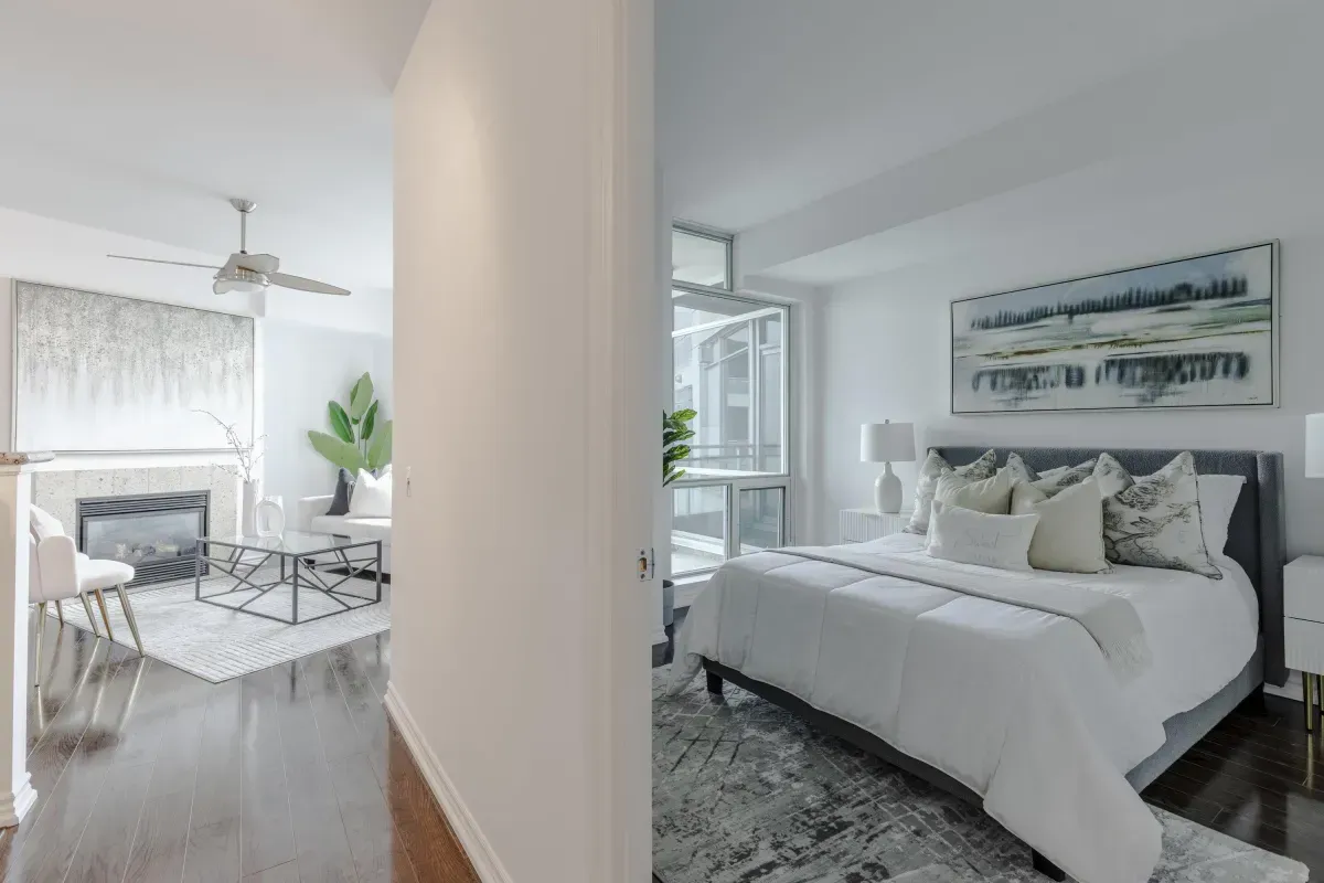 Spacious primary bedroom at 5 Marine Parade Dr #630, Etobicoke, featuring mirrored closets, hardwood floors, and balcony access.
