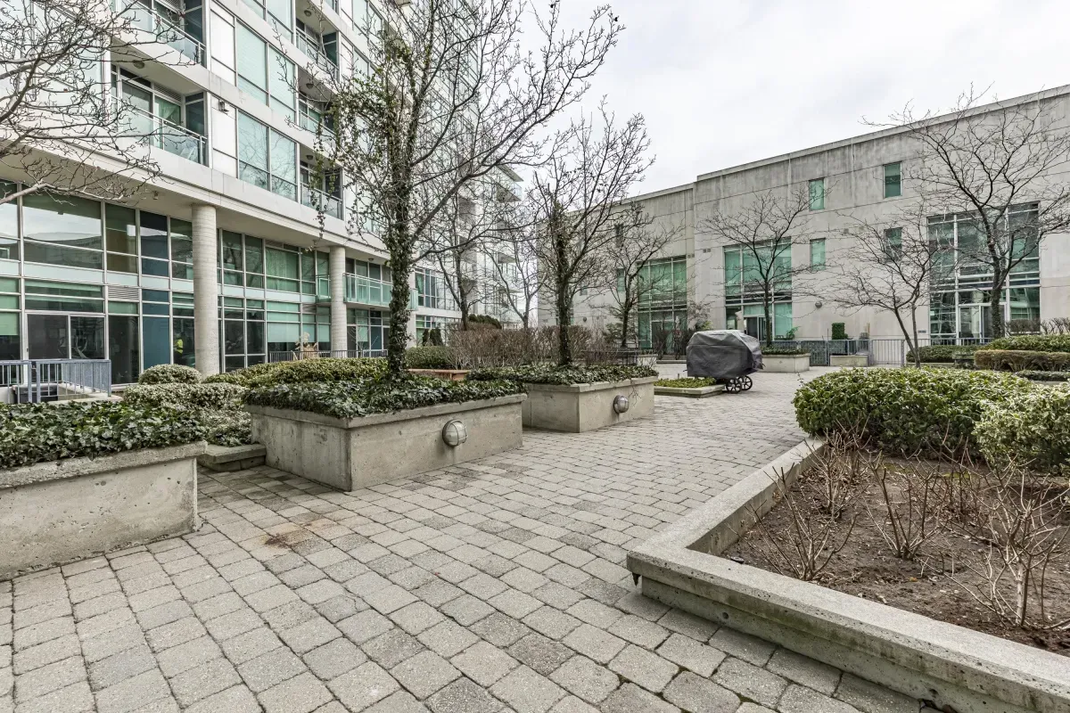 Beautifully maintained outdoor courtyard at 5 Marine Parade Dr #630, Etobicoke, featuring stone pavers and manicured greenery.