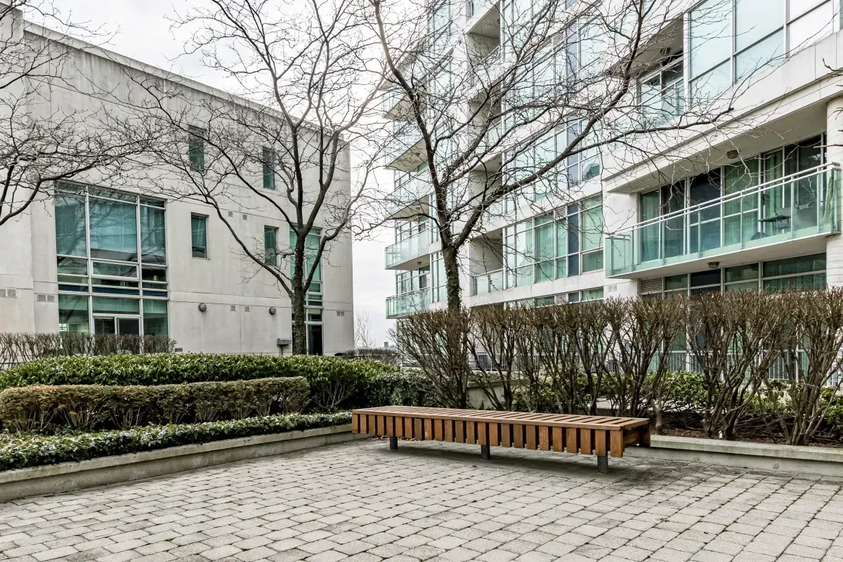 Relaxing outdoor bench seating within the quiet community courtyard of 5 Marine Parade Dr #630, Etobicoke.