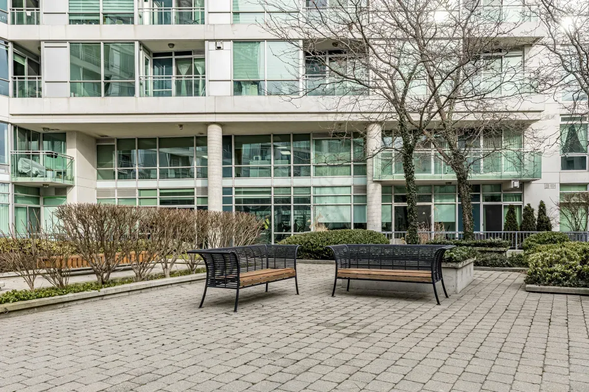 Relaxing outdoor bench seating within the quiet community courtyard of 5 Marine Parade Dr #630, Etobicoke.