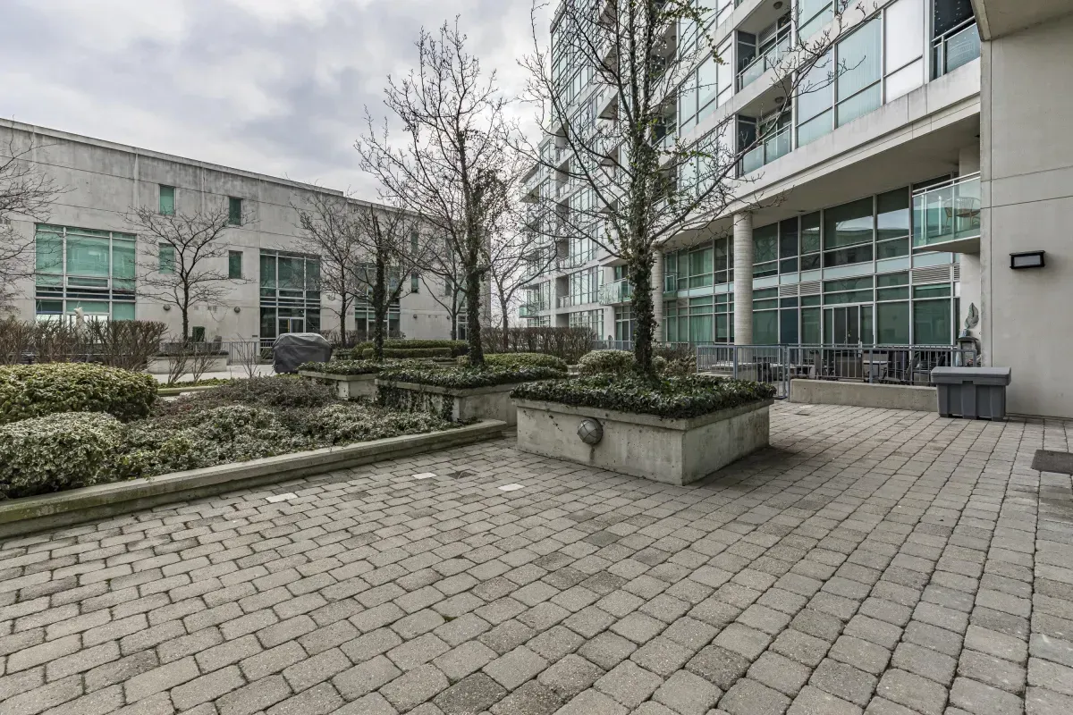 Beautifully maintained outdoor courtyard at 5 Marine Parade Dr #630, Etobicoke, featuring stone pavers and manicured greenery.