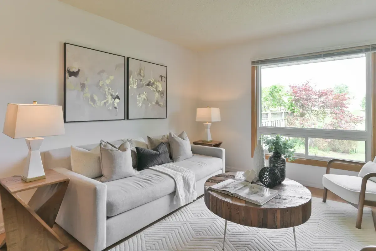 Open-concept living room featuring large windows, hardwood-style flooring, and contemporary staging at 2286 Margot St, Oakville.