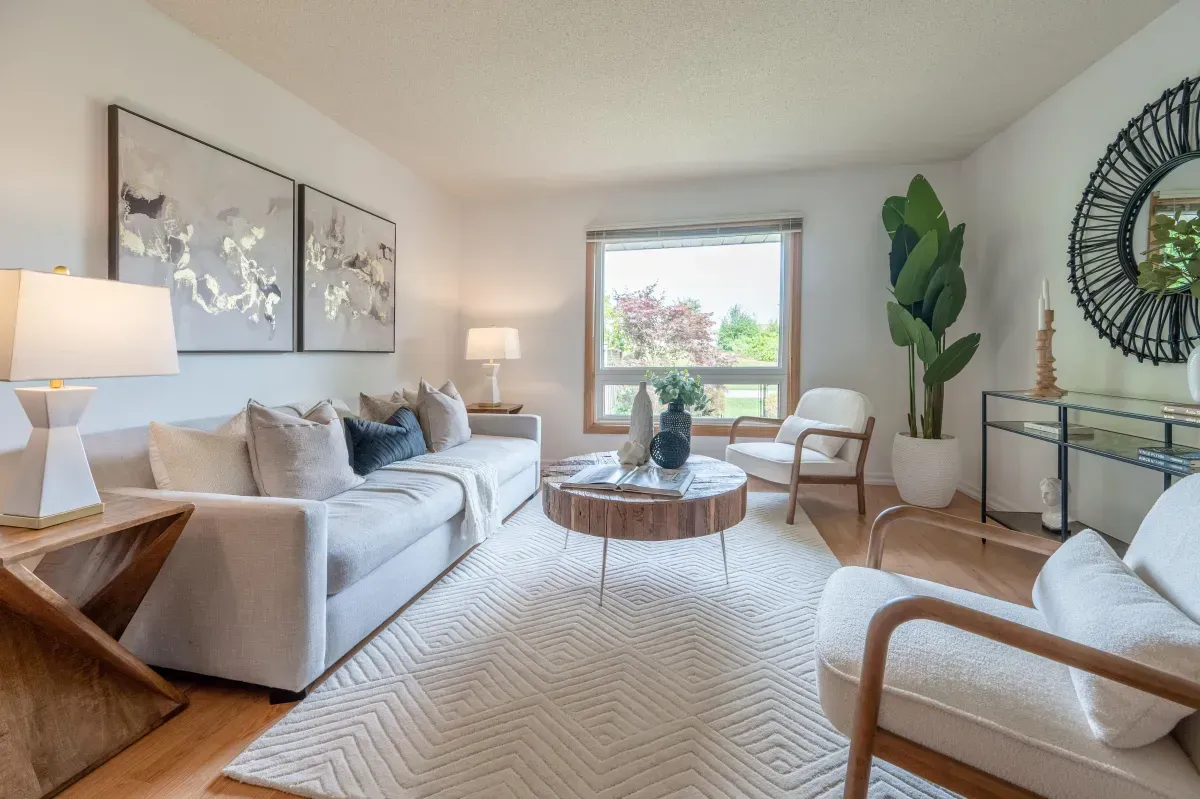 Open-concept living room featuring large windows, hardwood-style flooring, and contemporary staging at 2286 Margot St, Oakville.