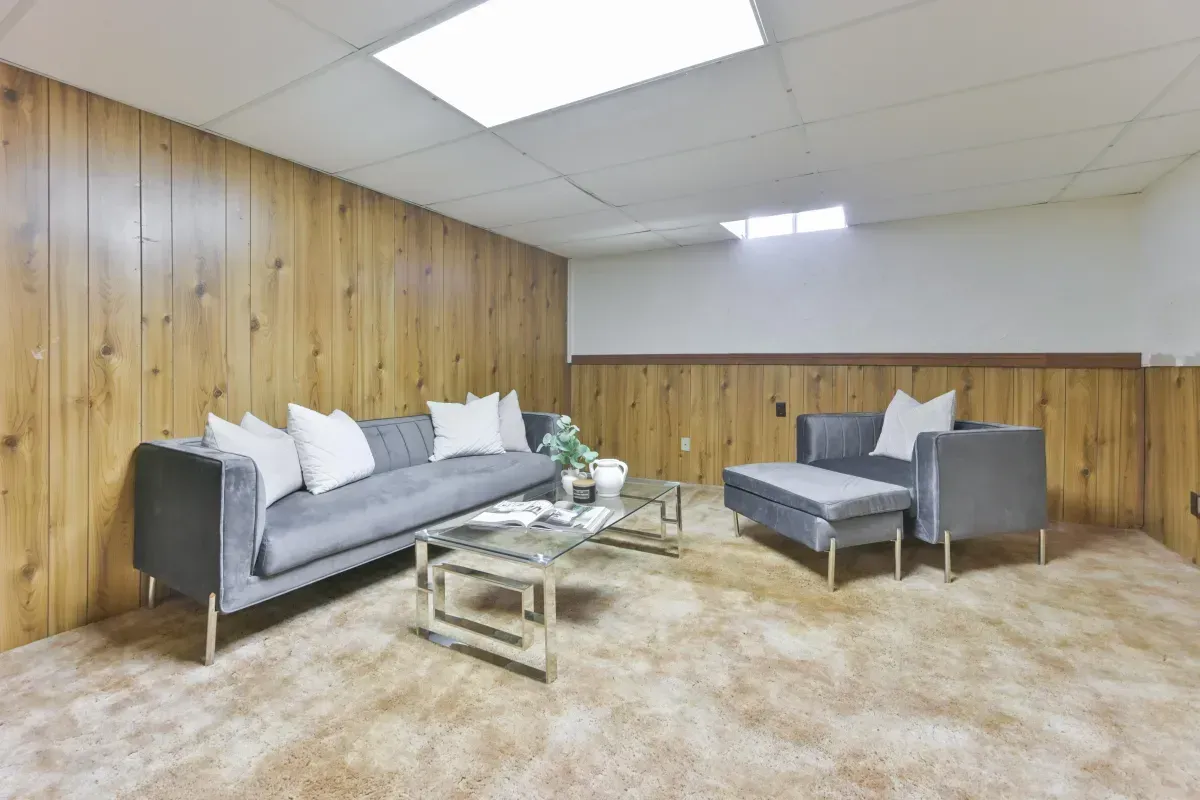 Versatile lower-level recreation room or 4th bedroom with wood-panel accents at 2286 Margot St, Oakville.