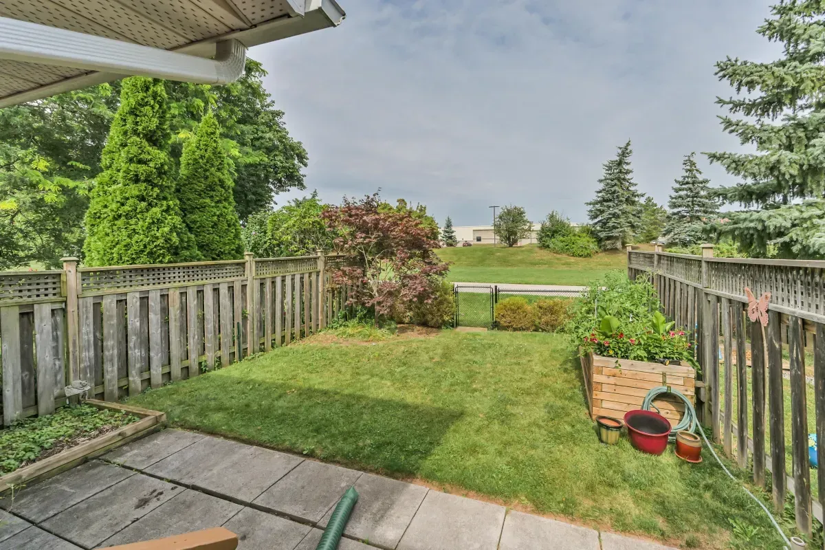 Fully fenced, private backyard sanctuary at 2286 Margot St, Oakville, featuring a patio area for outdoor entertaining.
