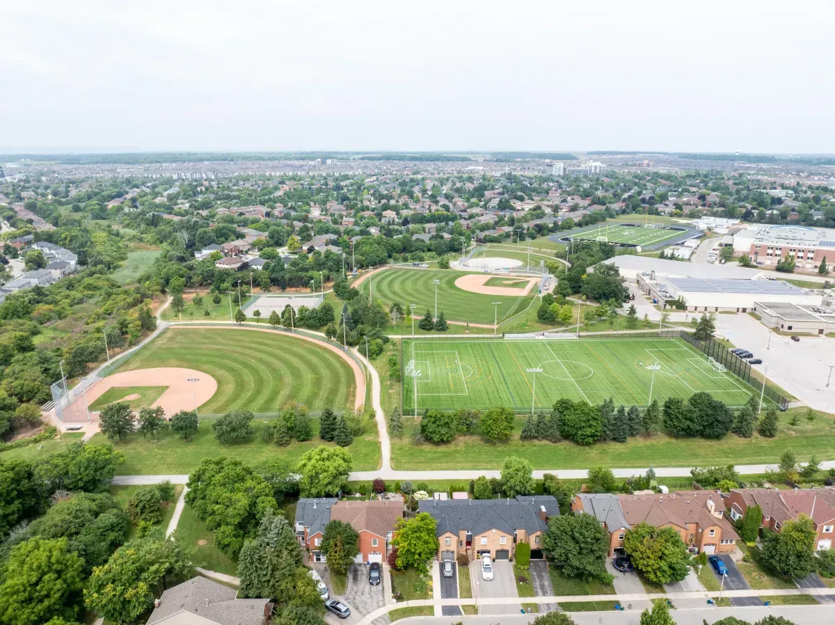 Aerial perspective of the sports fields and community infrastructure surrounding the home at 2286 Margot St, Oakville.