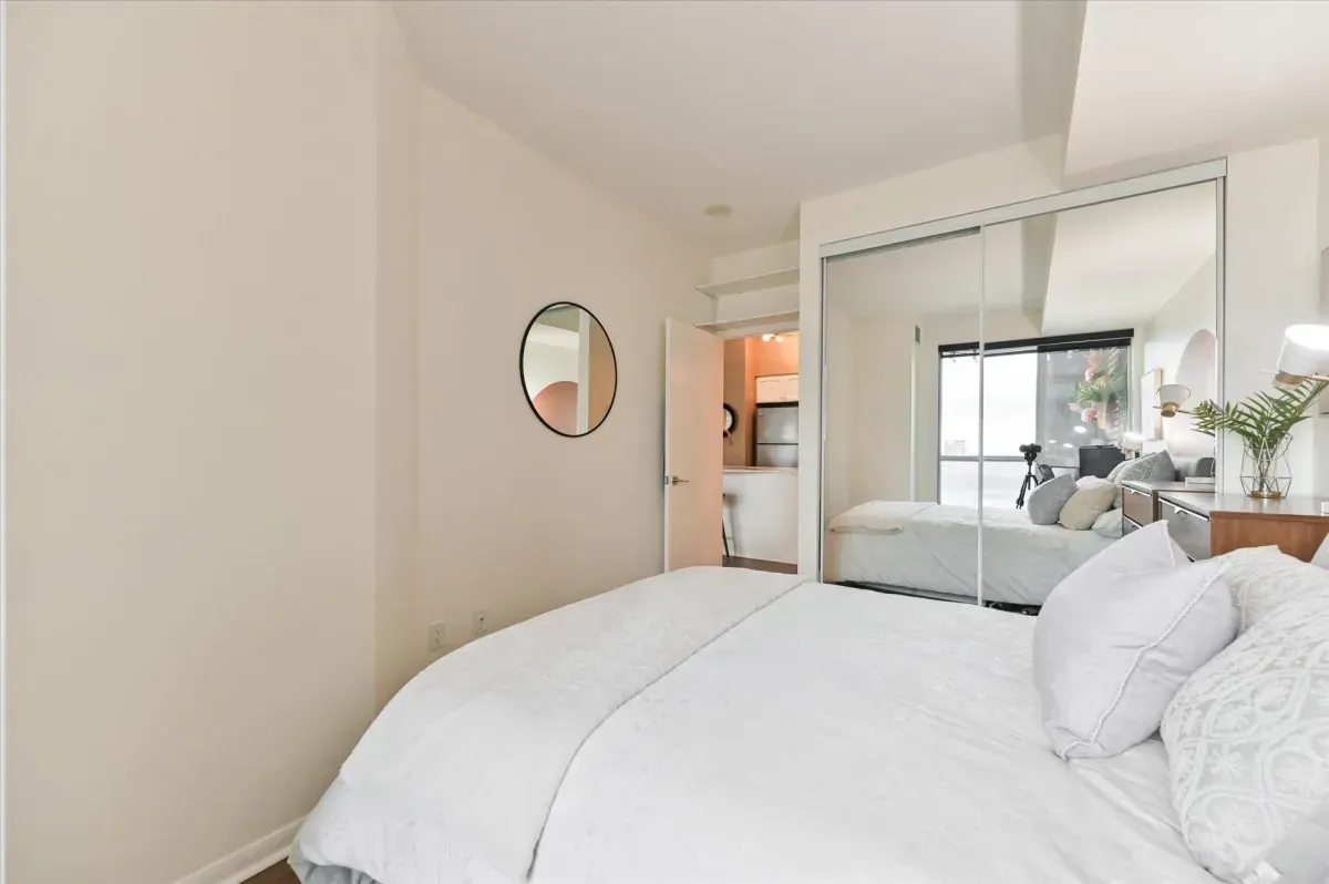 Bright 1-bedroom suite at 219 Fort York Blvd #3301 with large windows and mirrored closets.