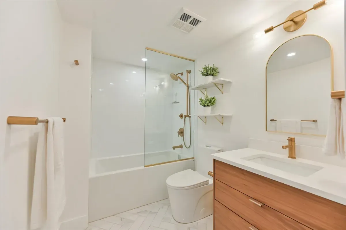 Spa-inspired bathroom with modern vanity, gold hardware, and high-end tile finishes.