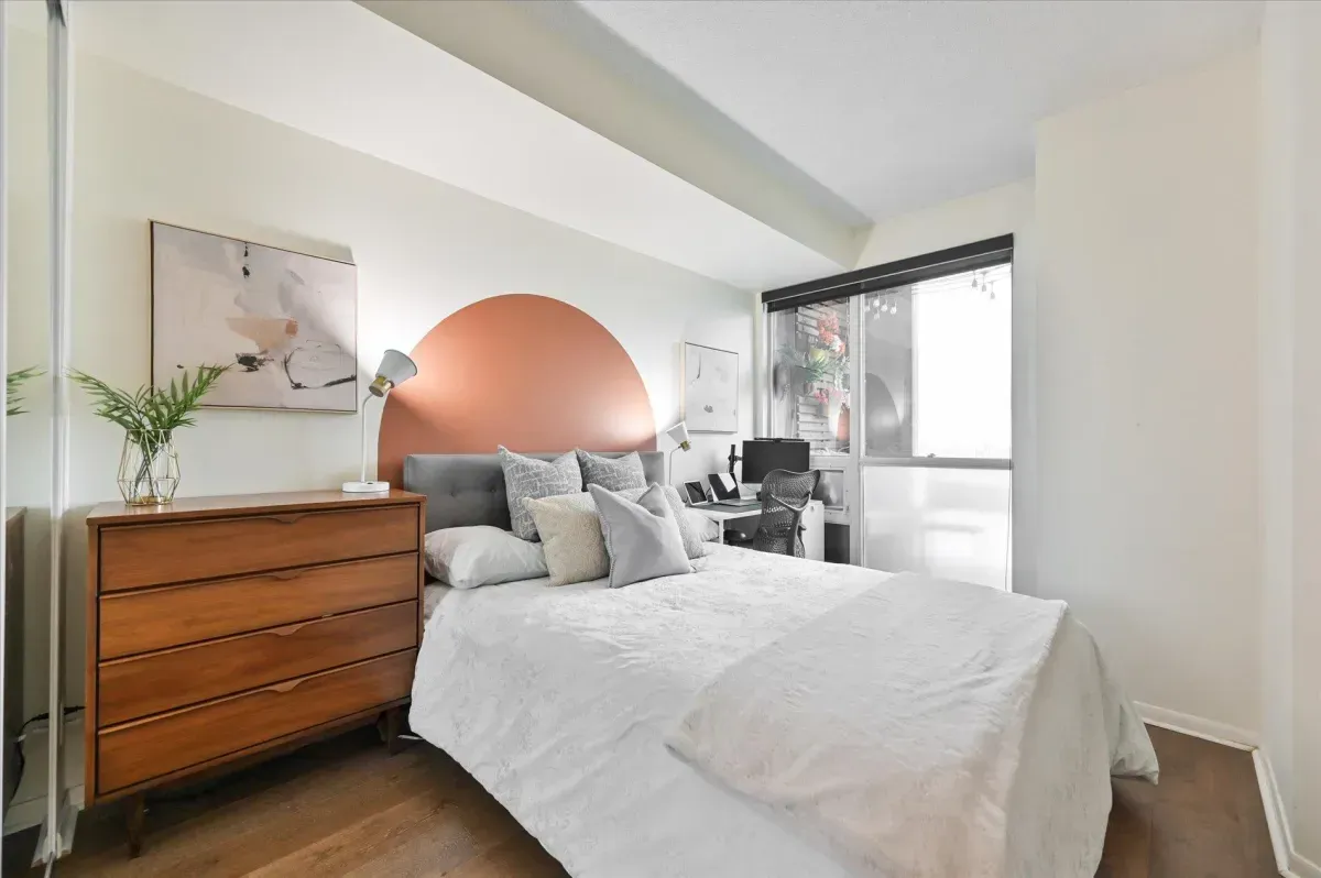 Bright 1-bedroom suite at 219 Fort York Blvd #3301 with large windows and mirrored closets.