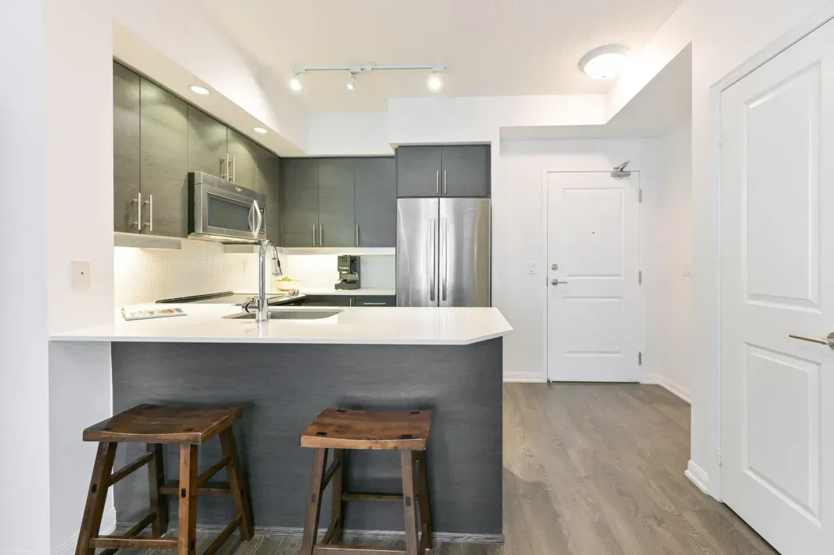 Modern kitchen at 85 E Liberty St #1909 featuring granite countertops, stainless steel appliances, and a social breakfast bar.