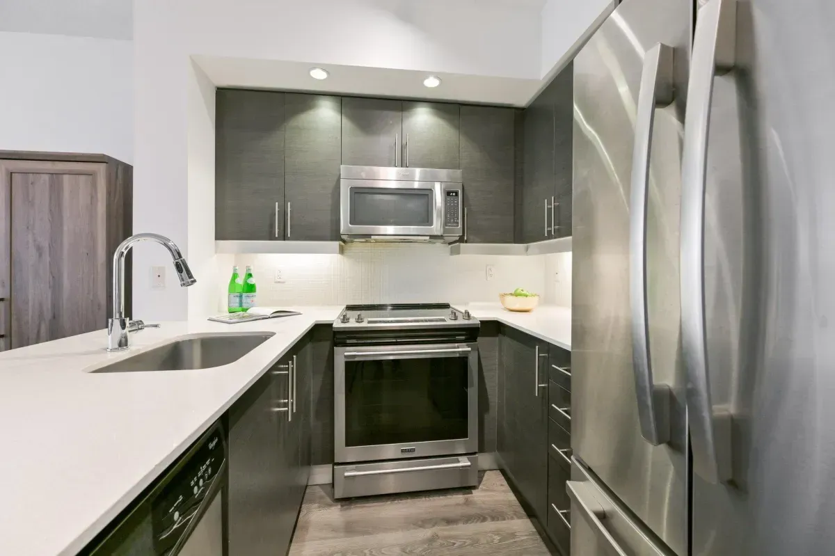 Modern kitchen at 85 E Liberty St #1909 featuring granite countertops, stainless steel appliances, and a social breakfast bar.