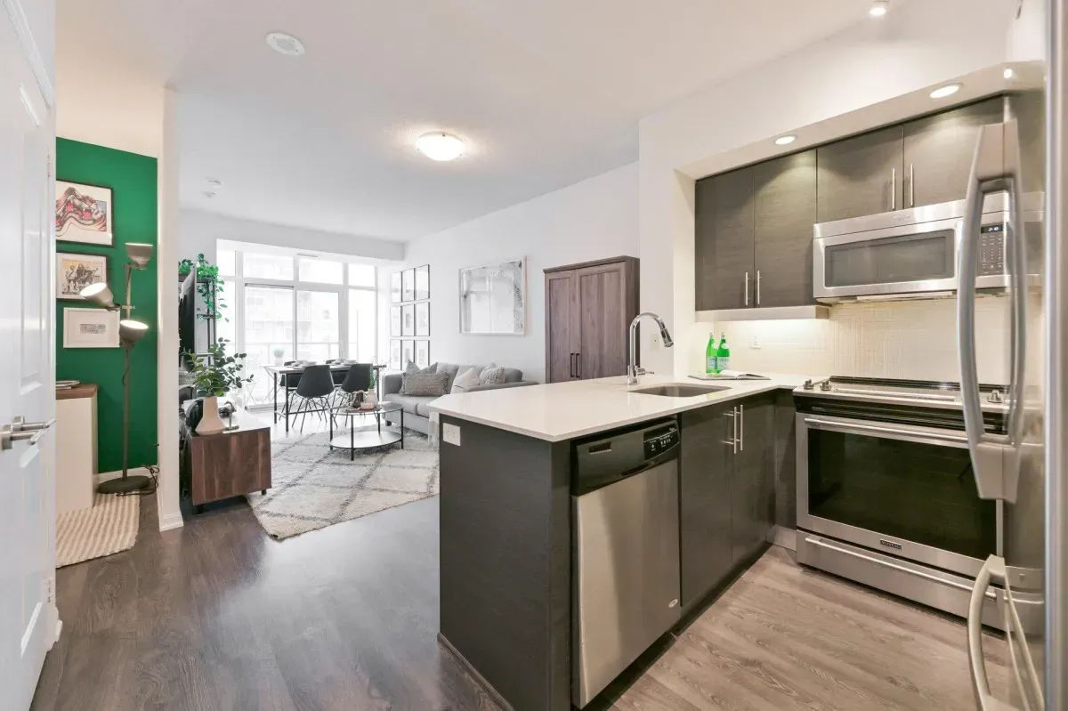 Modern kitchen at 85 E Liberty St #1909 featuring granite countertops, stainless steel appliances, and a social breakfast bar.