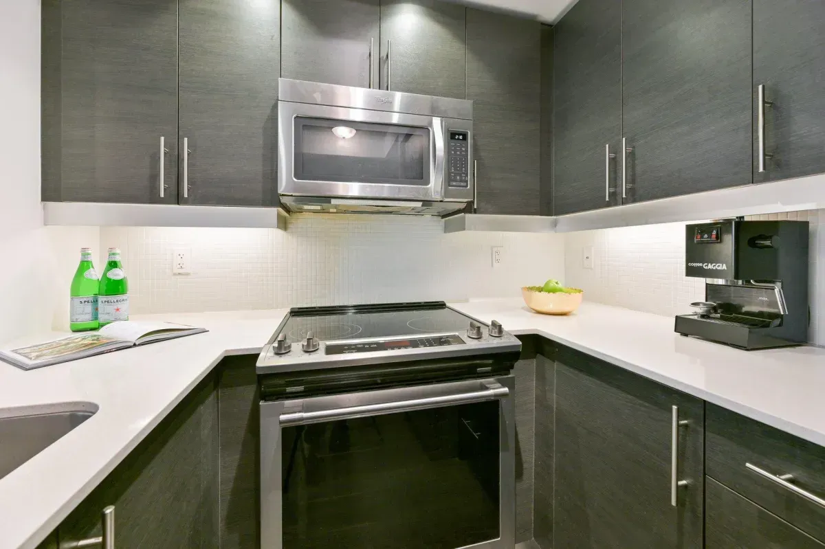 Modern kitchen at 85 E Liberty St #1909 featuring granite countertops, stainless steel appliances, and a social breakfast bar.