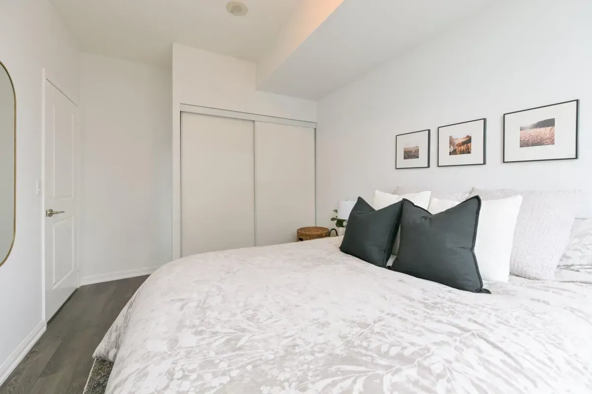 Spacious 1-bedroom suite with neutral decor and large windows overlooking downtown Toronto.