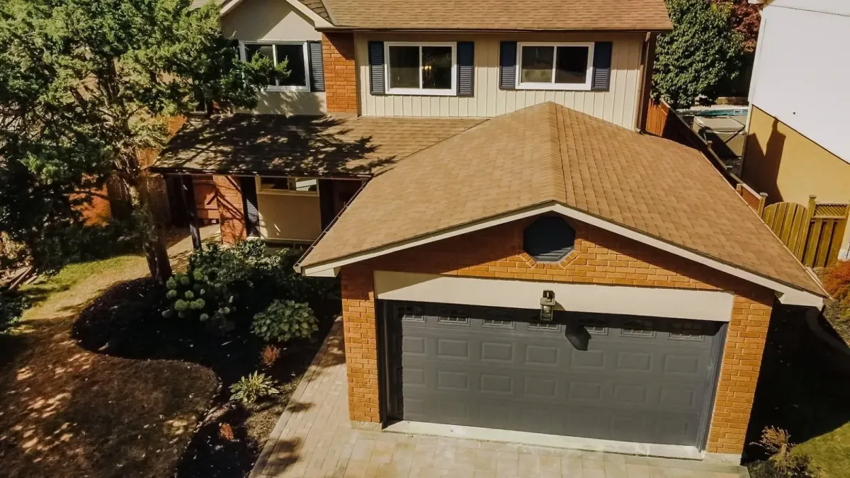 Front exterior of 110 Holliday Dr, Whitby, featuring a brick facade, double garage, and landscaped front garden.
