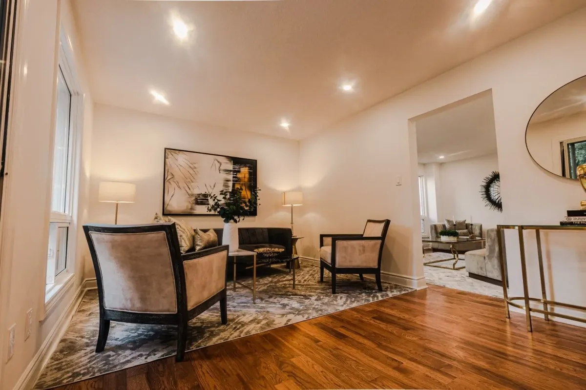 Secondary view of the living room at 110 Holliday Dr with designer furniture and gold décor accents.