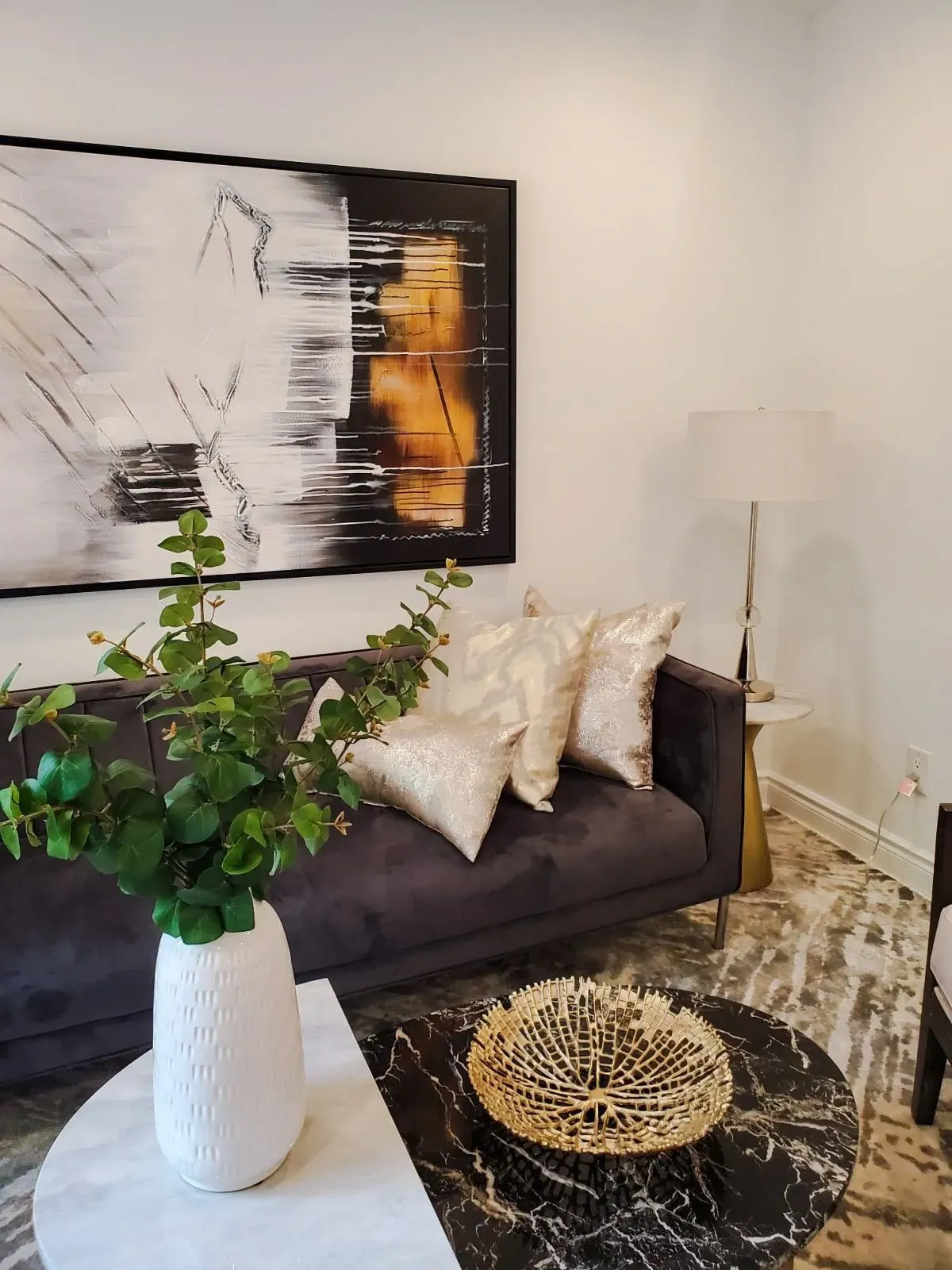 View of the designer-staged living room at 110 Holliday Dr highlighting the hardwood floors and natural light.