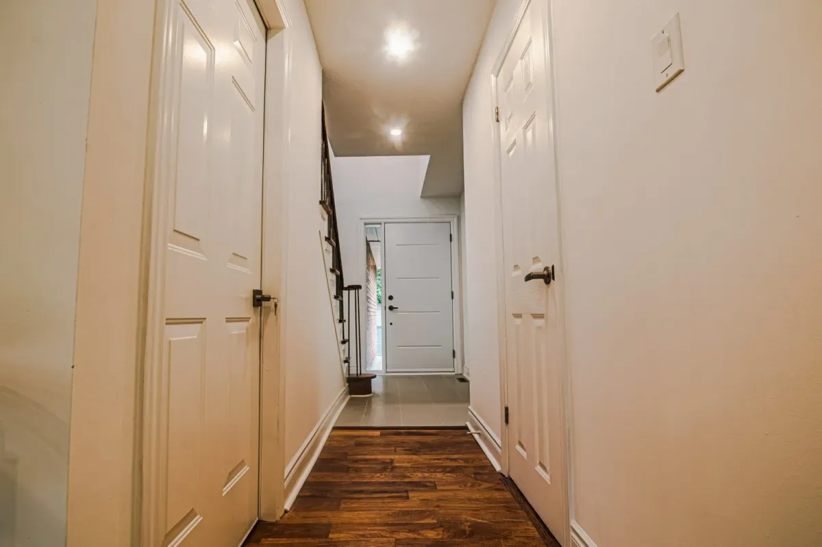 Bright hallway at 110 Holliday Dr with hardwood floors leading to the main level living areas.