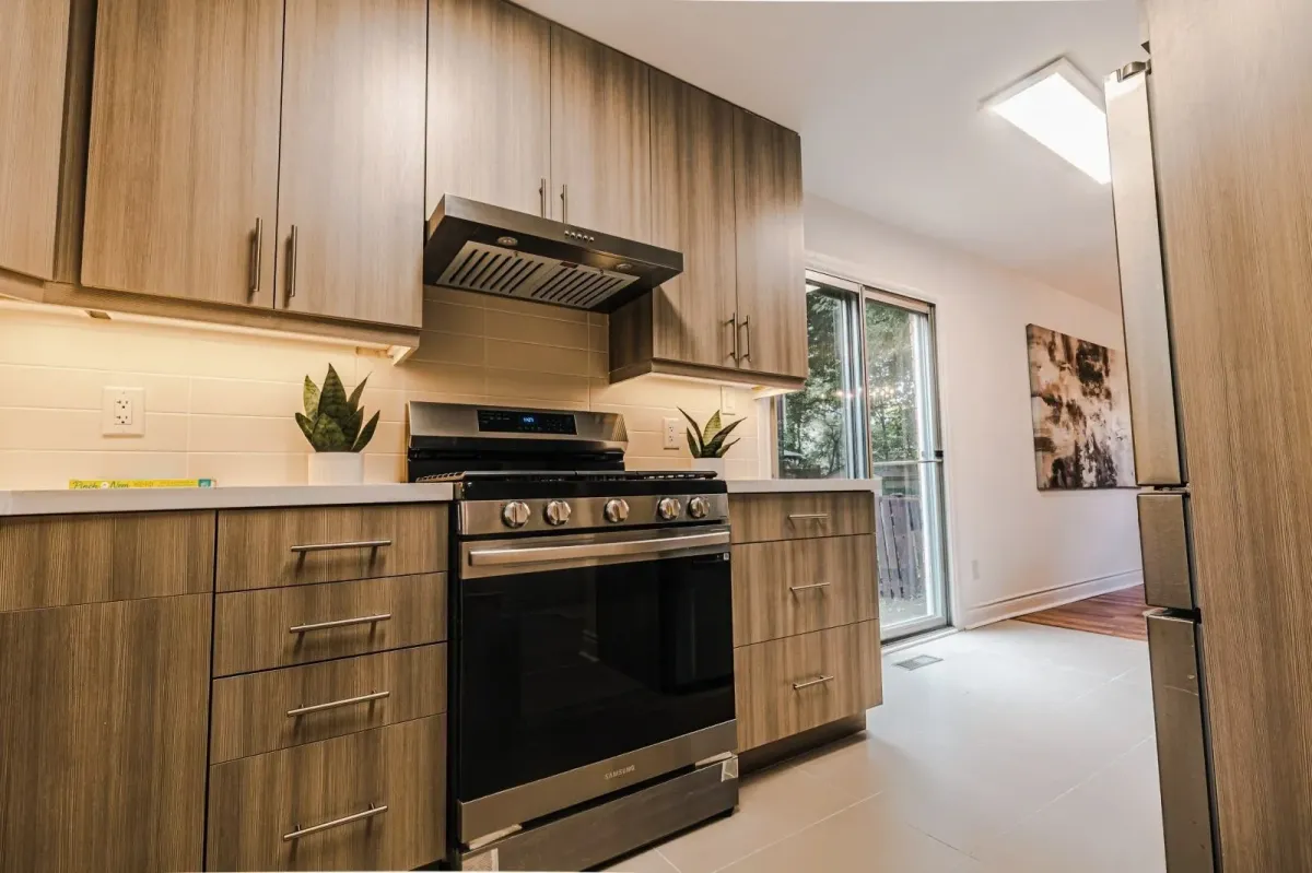 Modern kitchen workspace at 110 Holliday Dr with custom grey cabinetry and professional-grade appliances.